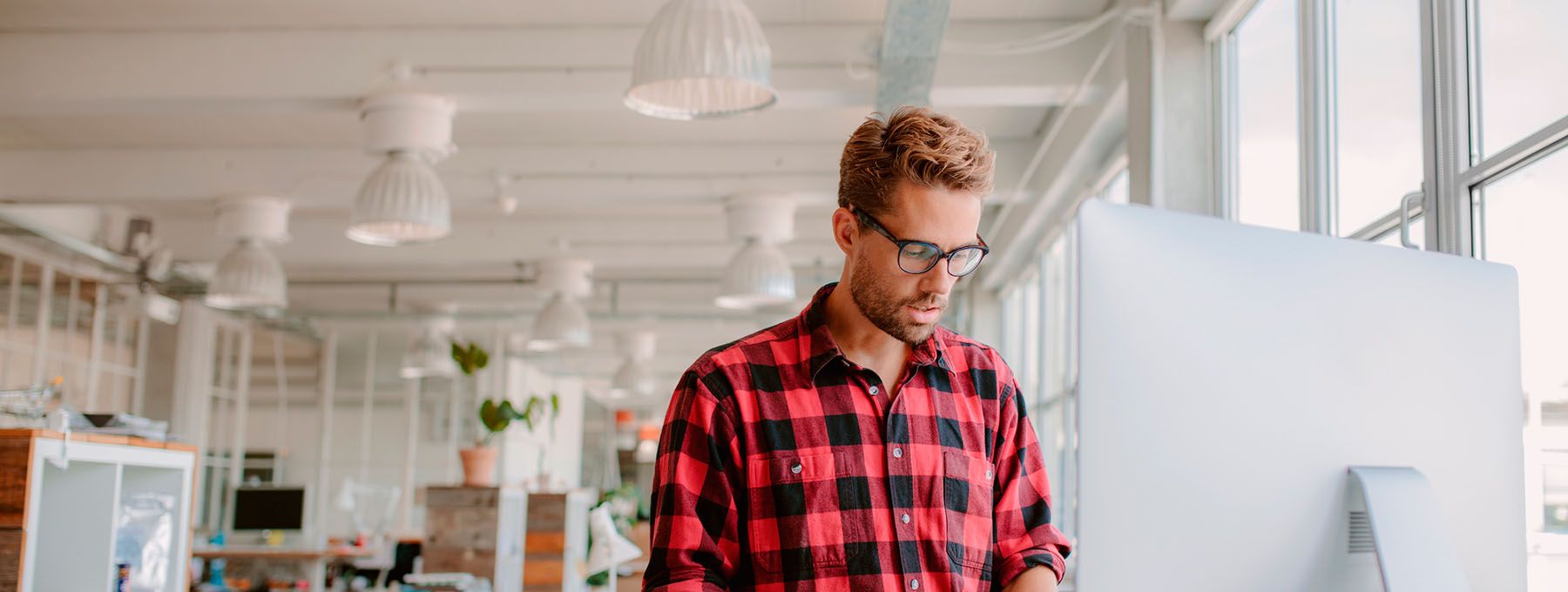 Boy looks at his computer to check his email backup