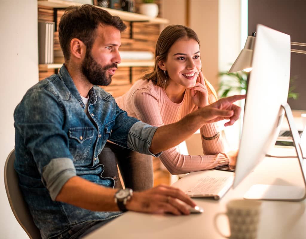 Coworkers check their email backup on their computer.