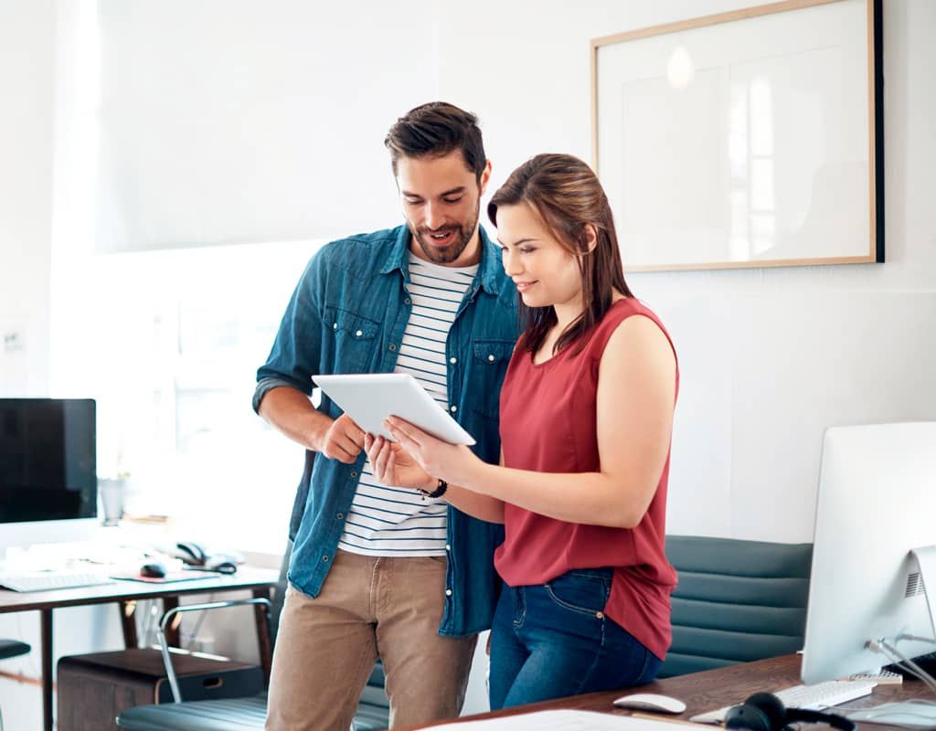 Coworkers check their email backup on their tablet.