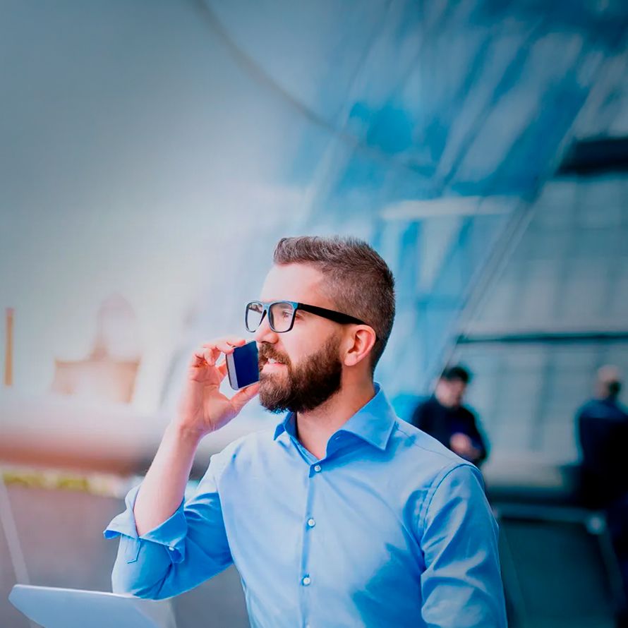 Boy talks on the phone while managing his PC backup on his computer