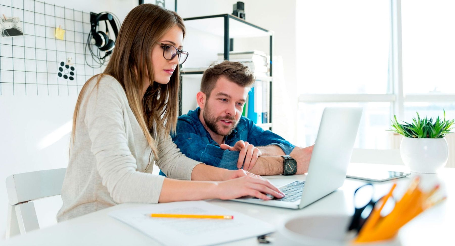 Colleagues working on their laptop to redirect their domains to the main one
