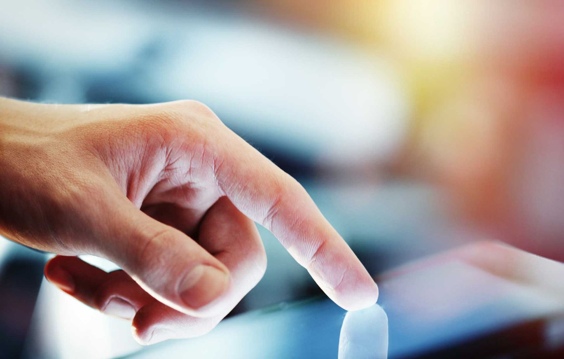 Finger clicking on a tablet to redirect your domains to the main one