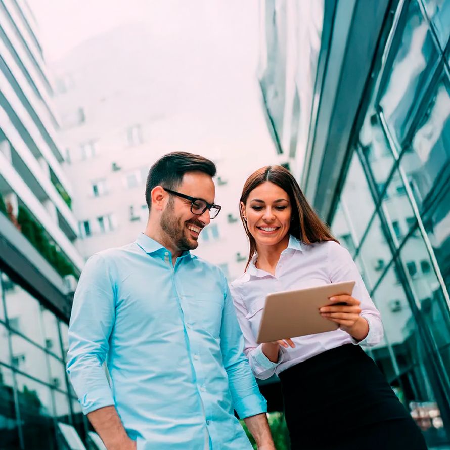 Coworkers sharing their domain reseller data on a tablet