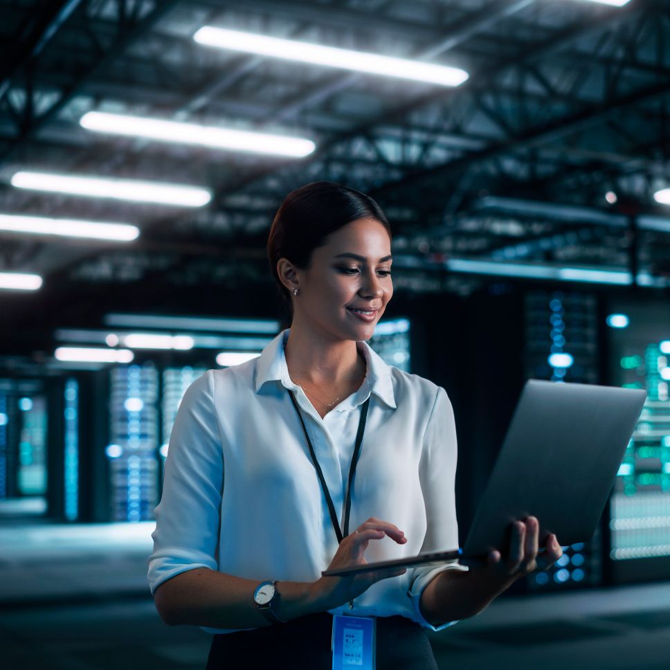 Professional consulting their computer in a data center