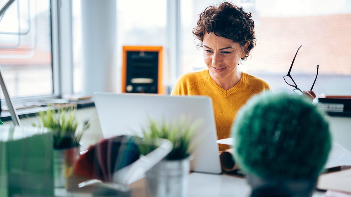 A girl using her computer to check which directories her business appears in with Find Your Business