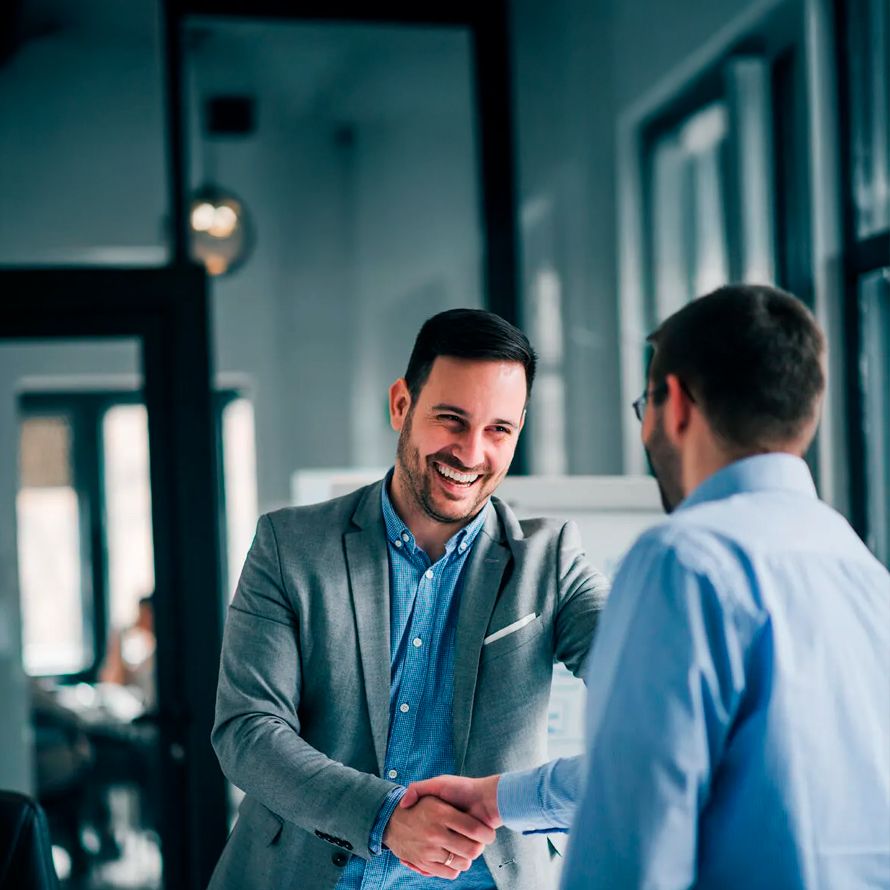 Colleagues shaking hands to congratulate each other for connecting their clouds without worries