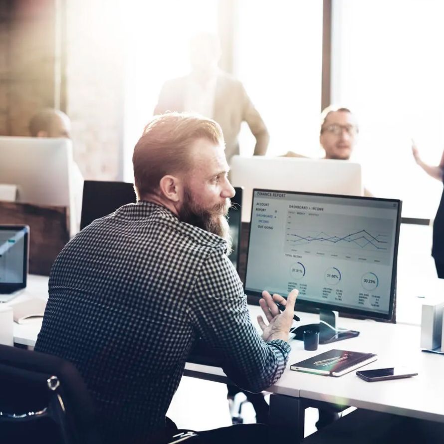 Boy looking at a graph on his computer about Devops-Kubernetes technology in the cloud