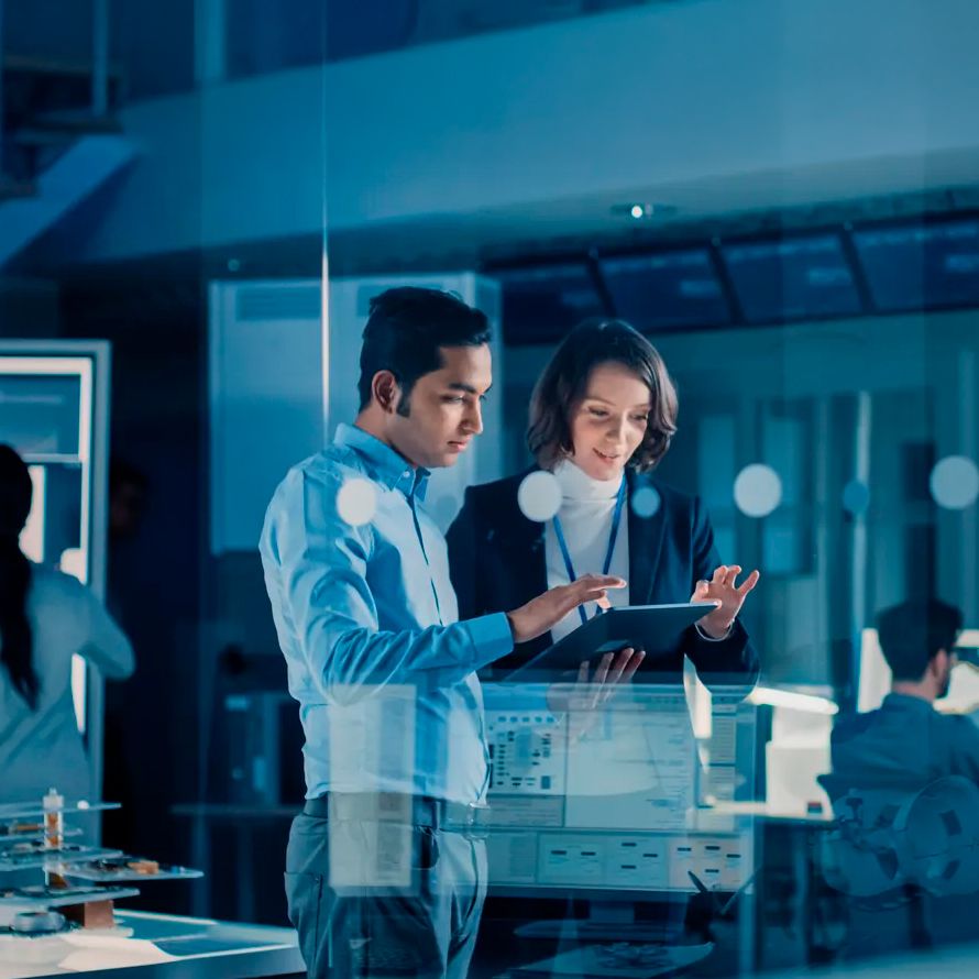 Colleagues discussing cyber defense and data protection against cyberattacks in front of a tablet.