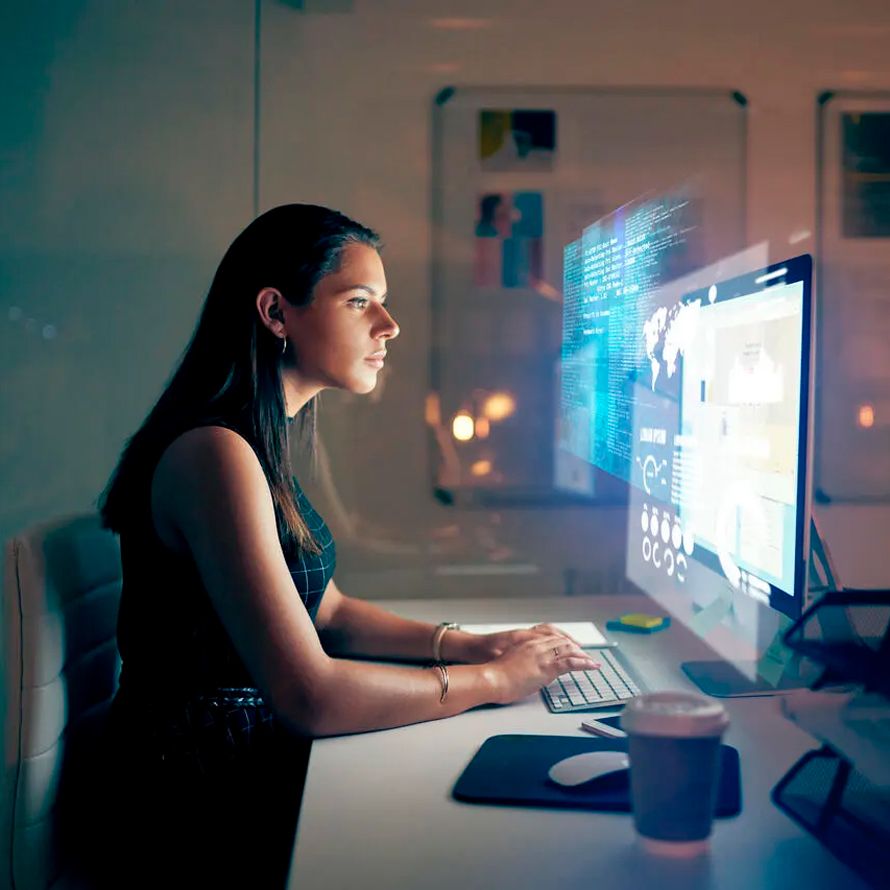 Girl in front of a screen with graphics about outsourcing IT services for her project