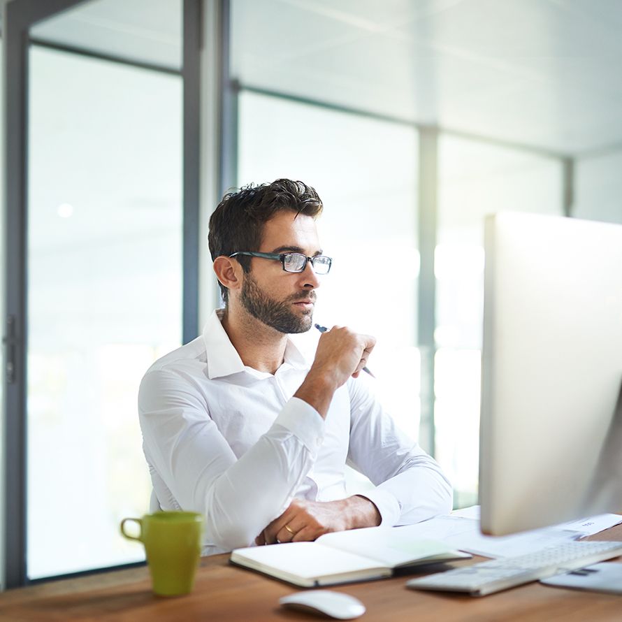 Boy concentrating in front of his laptop studying the custom IoT solution we designed for him