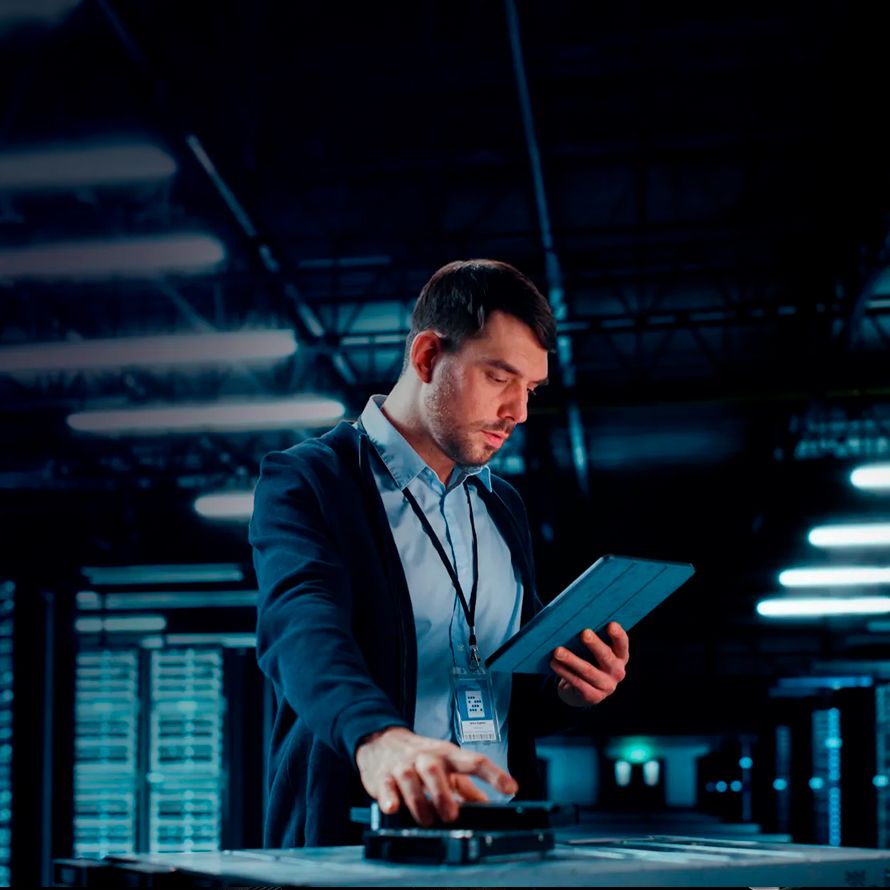 Systems administrator focused on his tablet to optimize platforms and secure their trajectory