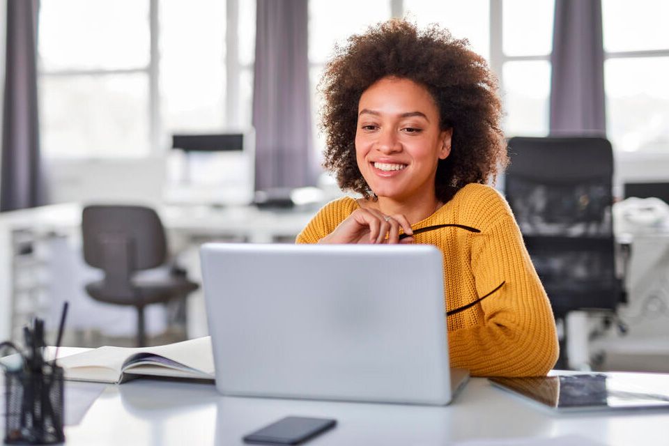 Girl checks her computer without worries because she has our Professional Antivirus service